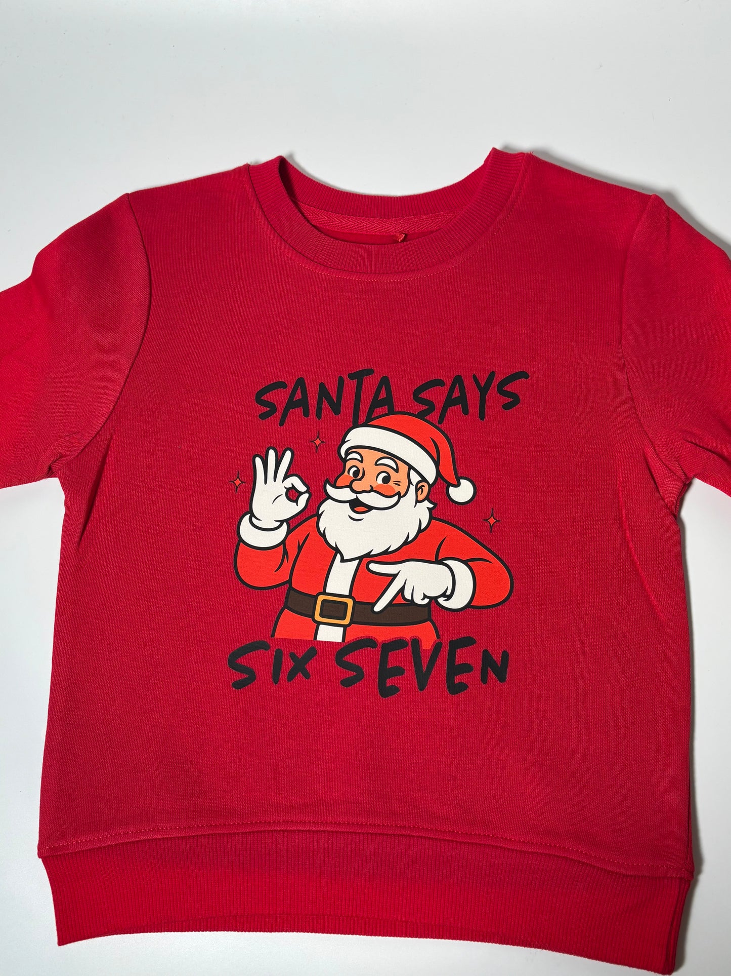 āSanta Says Six Sevenā Childrenās Christmas Jumper